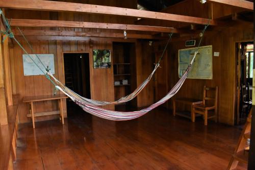 a hammock hanging from the ceiling of a room at El Descanso in Mindo