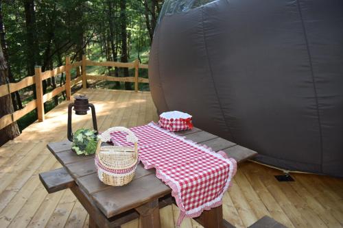 a picnic table on a deck with a tent at Bubble room sul tetto della Puglia in Biccari