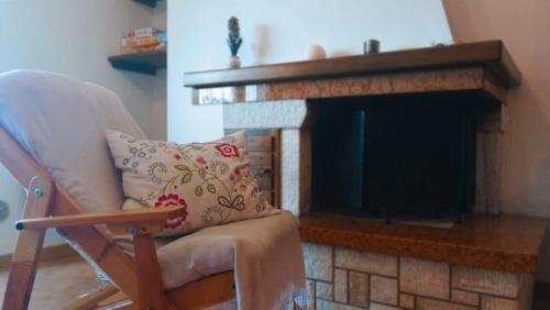 a living room with a chair and a fireplace at Casa Alice in Camigliatello Silano