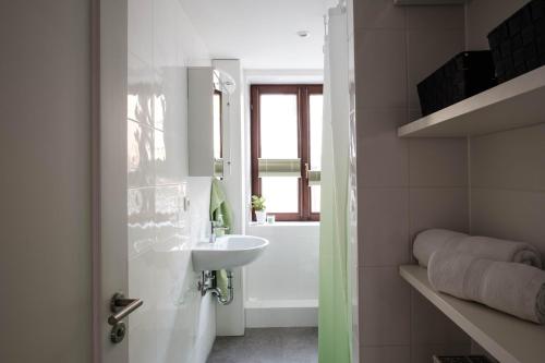 a bathroom with a sink and a bath tub at FeWo Alte Mainbrücke in Würzburg