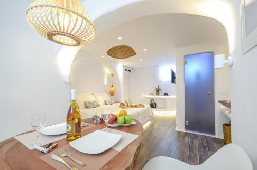 a kitchen and living room with a sink and a couch at Naxos Island Escape Suites in Plaka