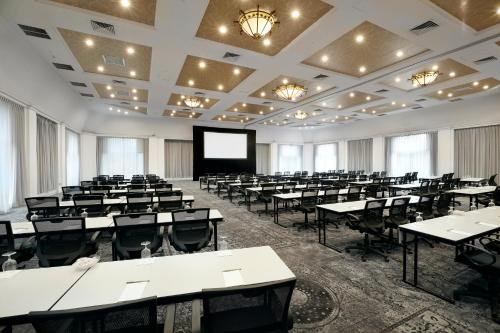 a large room with tables and chairs and a screen at Tarrytown House Estate in Tarrytown