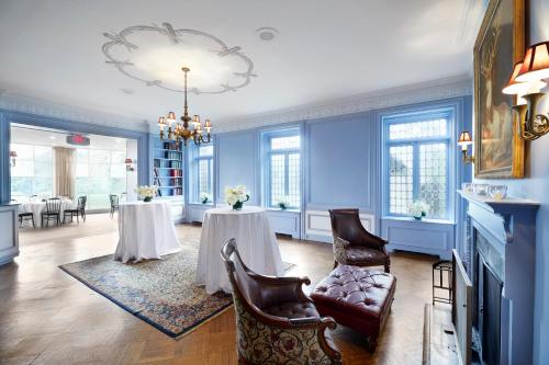 a living room with two tables and a chandelier at Tarrytown House Estate in Tarrytown