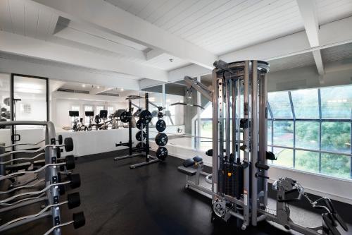 a gym with several tread machines in a room at Tarrytown House Estate in Tarrytown