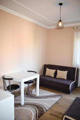 a living room with a white table and a couch at Apartments Hillside in Ulcinj