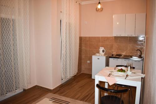 a small kitchen with a white table and a counter top at Apartments Hillside in Ulcinj