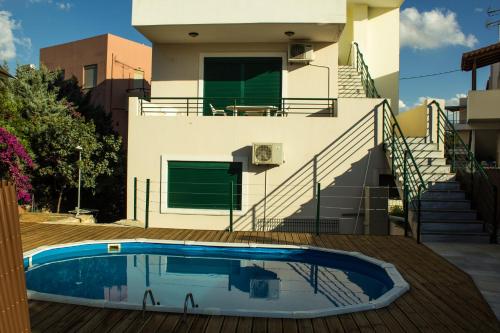 a house with a swimming pool in front of a house at Cretan Dream Apartments in Atsipopoulo