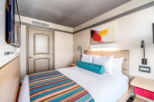 a hotel room with a bed and a flat screen tv at Century Park Hotel LA in Los Angeles
