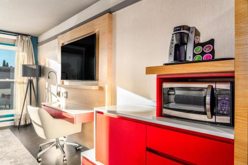 a kitchen with a microwave on top of a red cabinet at Century Park Hotel LA in Los Angeles