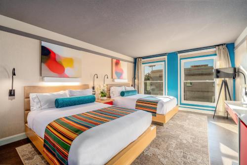 a hotel room with two beds and a window at Century Park Hotel LA in Los Angeles
