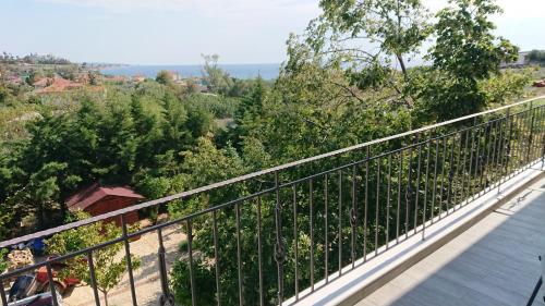 a balcony with a view of a forest at Stone house with seaview in Nea Potidaea