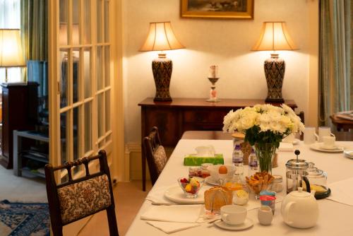 a dining room with a table with food and flowers at Georgian House in Edinburgh