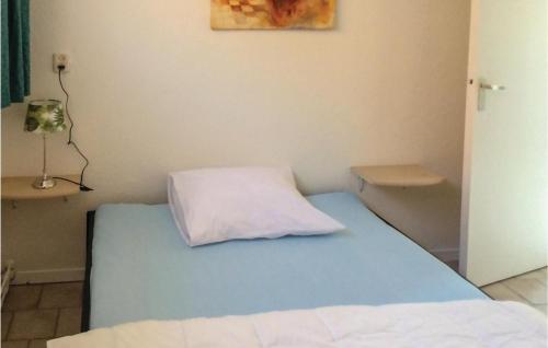 a bedroom with a bed with a pillow on it at Appartement 3 - De Eekhof in Hindeloopen