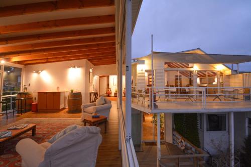 a house with a deck and a living room at Kai Bed and Breakfast in Algarrobo