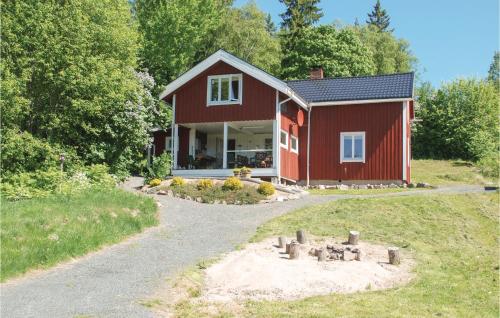 a red house with a pathway leading to it at Stunning Home In Nordmarkshyttan in Nordmarkshyttan