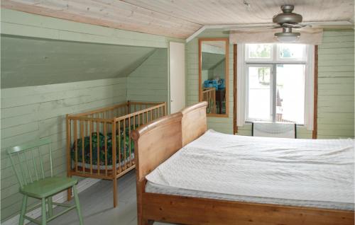 a bedroom with a bed and a chair and a window at Stunning Home In Nordmarkshyttan in Nordmarkshyttan