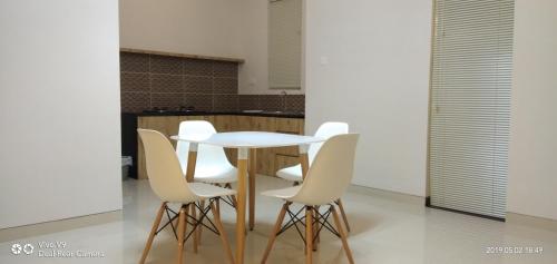 a white table and white chairs in a kitchen at SleepRest @ The Home Shoutlink in Nagoya