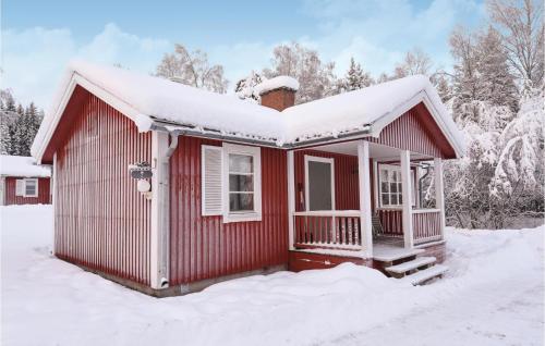 a red house with snow on the roof at Amazing Home In Sysslebäck With Kitchen in Sysslebäck