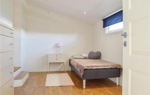 a small bedroom with a bed and a window at Nice Home In Uddevalla With Wifi in Uddevalla