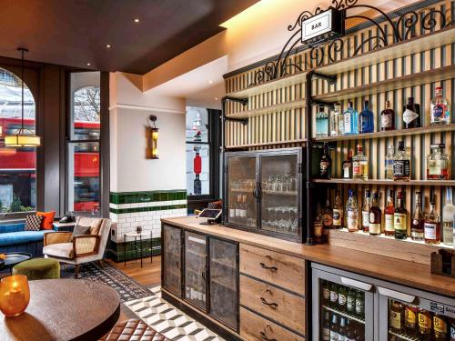 a bar with a lot of bottles of alcohol at ibis Styles London Gloucester Road in London