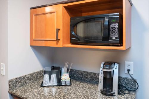 a microwave sitting on top of a kitchen counter at Pocaterra Inn & Waterslide in Canmore