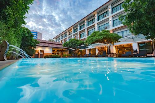 a swimming pool in front of a hotel at The Pannarai Hotel in Udon Thani