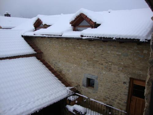 a snow covered roof of a house at O´Porron in Sabiñánigo