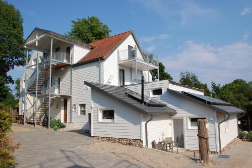a large white building with a staircase on it at Schlafstrandkorb Nr.2 in Sierksdorf