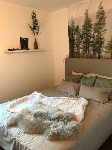 a bed with a furry blanket on it at Trajadinha - Swedish House in Caminha