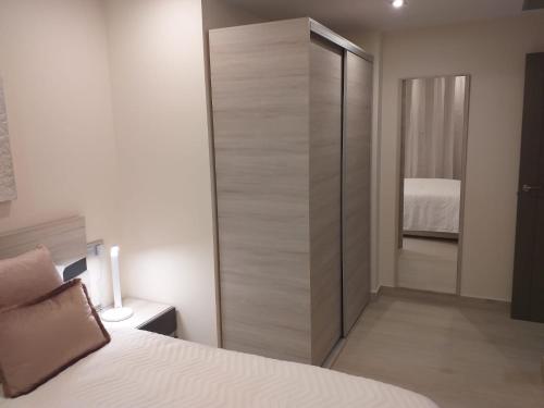 Ein Bett oder Betten in einem Zimmer der Unterkunft Apartamentos Vacacionales Joctis, 2º A