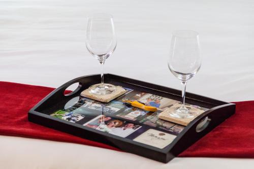 a tray with two wine glasses on a red napkin at The Vendange Carmel Inn & Suites in Carmel