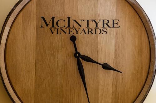 a wooden clock with the name of multiple wineyards on it at The Vendange Carmel Inn & Suites in Carmel