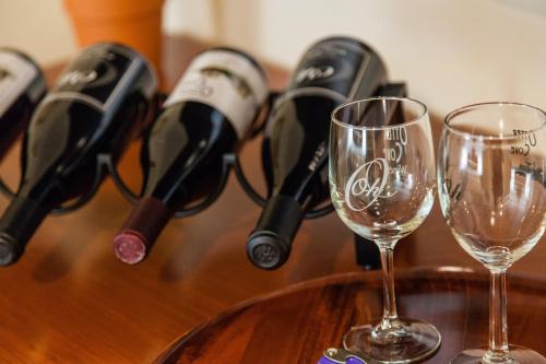 a group of wine bottles on a table with glasses at The Vendange Carmel Inn & Suites in Carmel
