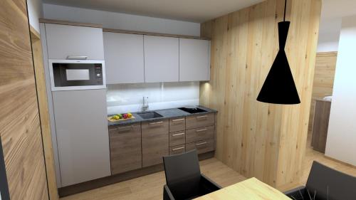 a kitchen with white cabinets and a table with chairs at Winklers Gipfelblick Chalet, inklusive Alpentherme - Ganzjährig, Gasteiner Bergbahn - nur Sommer in Bad Hofgastein