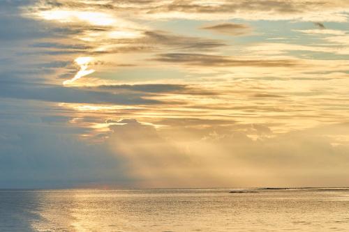 a view of the ocean with a cloudy sky at The Calm Resort & Spa in Pasikuda