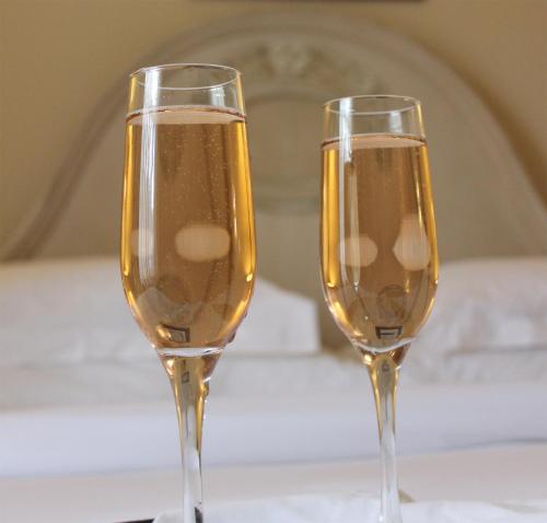 two champagne glasses sitting on a table at Coopmanhuijs Boutique Hotel & Spa in Stellenbosch