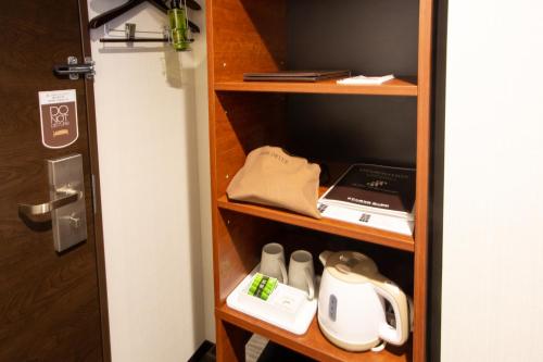 a shelf in a room with some items on it at Hotel Kuretakeso Takayama Ekimae in Takayama