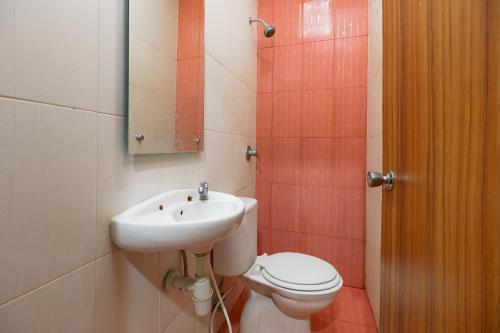 a bathroom with a toilet and a sink at RedDoorz Syariah near Simpang Surabaya Aceh in Banda Aceh