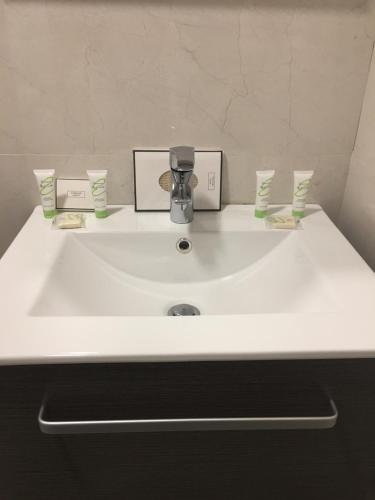 a white sink with a faucet in a bathroom at Beit Lebbos Boutique Hotel in Beït ed Dîne