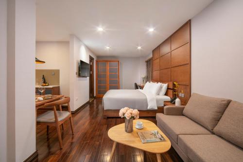 a hotel room with a bed and a couch at KEGON Inn in Hanoi