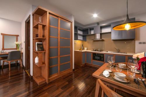 a kitchen with a table and a dining room at KEGON Inn in Hanoi