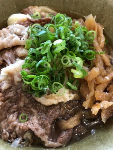 a plate of food with noodles and green onions at HOTEL MYTH-S -ホテル マイス エス- adult only in Sakaide