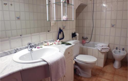 a white bathroom with a sink and a toilet at Beautiful Home In Santa Pola With Outdoor Swimming Pool in Santa Pola