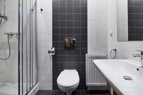 a bathroom with a toilet and a sink and a shower at Sztygarka. Pensjonat Pod Wieżą Katowice Chorzów in Chorzów