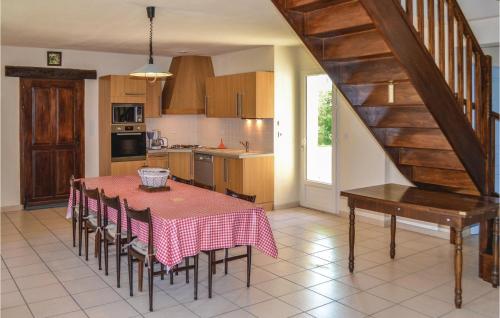 a kitchen and dining room with a table and chairs at Three-Bedroom Holiday Home In Montfaucon in Montfaucon