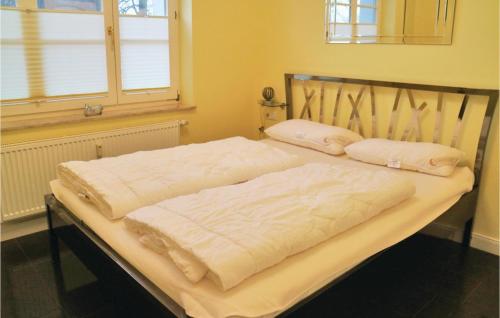 a bed with two pillows on it in a room at Fewo Sanssouci in Rerik