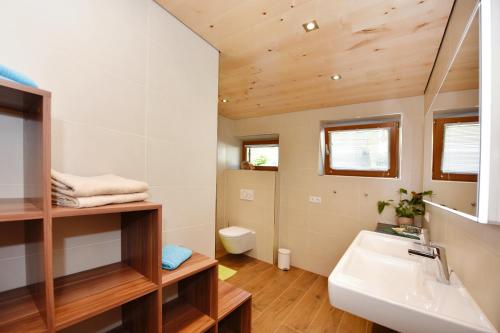 a bathroom with a sink and a toilet at Mottnerhof in Braz