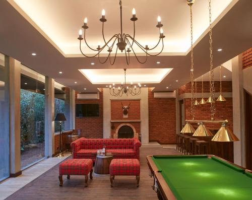 a pool table in a living room with a ping pong ball at The Argyle Luxury Boutique in Hatton