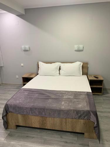 a bedroom with a large bed with two pillows at Marisol in Eforie Nord