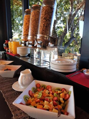 a plate of food on a table with a bowl of food at Greenfire Game Lodge in Balule Game Reserve